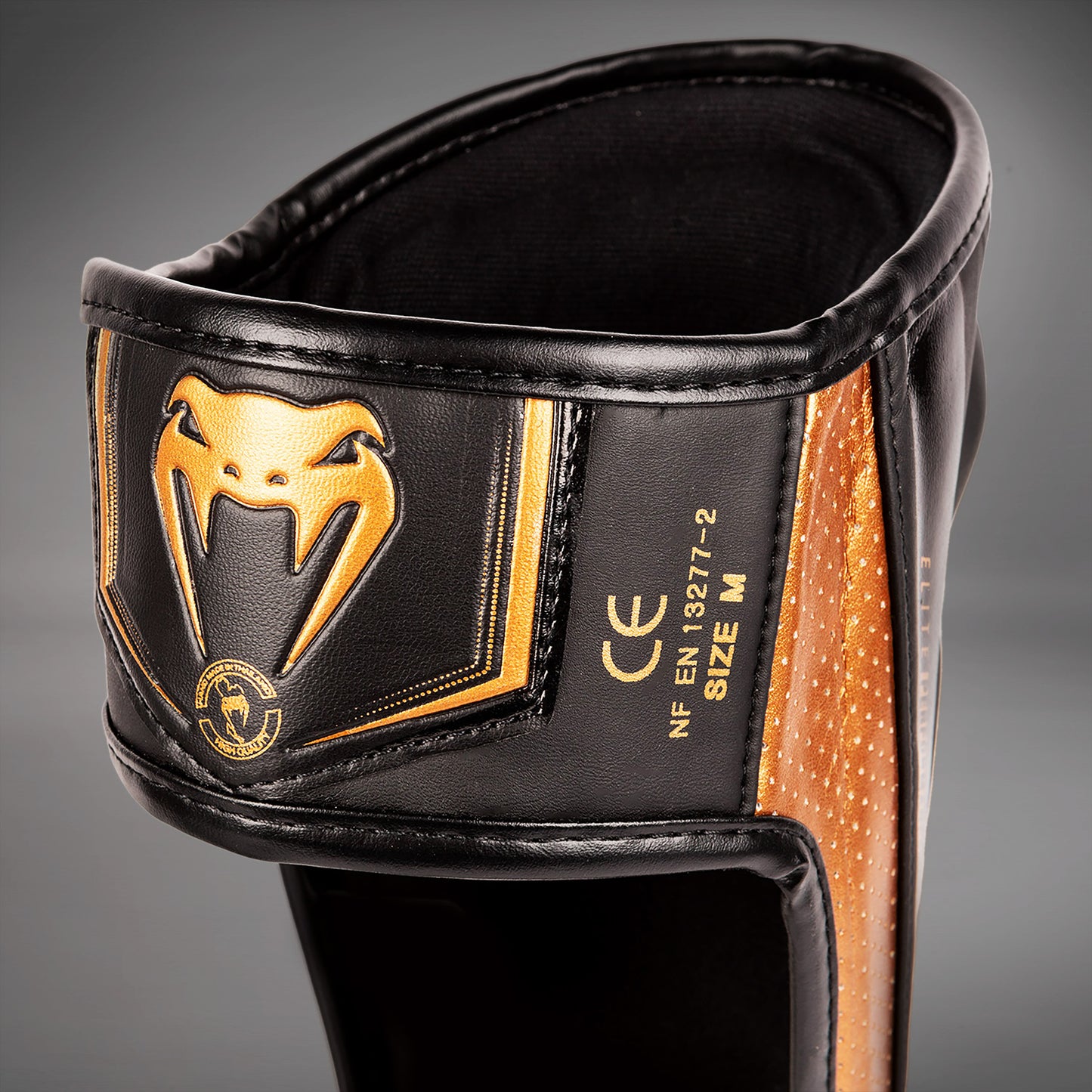 Venum Elite Evo scheenbeschermers - Zwart/Brons
